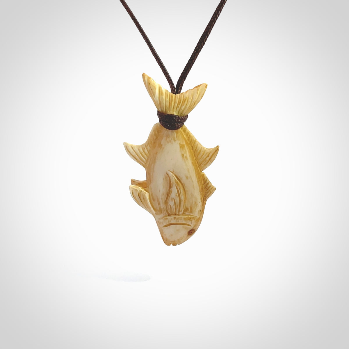 Hand carved stained bone fish pendant. Hand made stained bone fish necklace. Fish themed jewellery. Ocean themed pendant. Bone fish necklace provided with adjustable cord and free delivery.