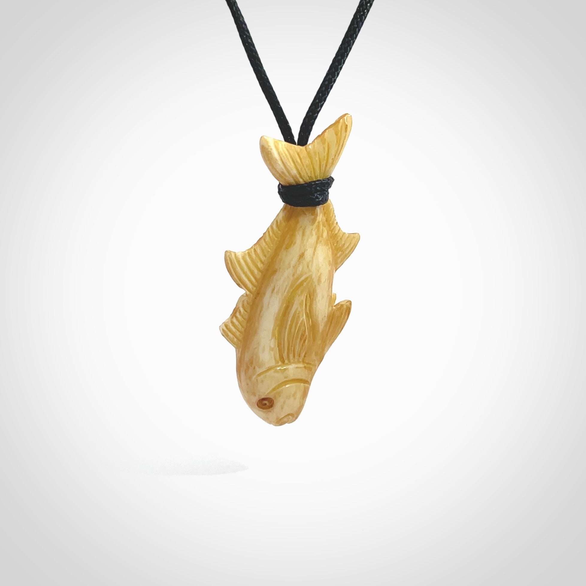 Hand carved stained bone fish pendant. Hand made stained bone fish necklace. Fish themed jewellery. Ocean themed pendant. Bone fish necklace provided with adjustable cord and free delivery.