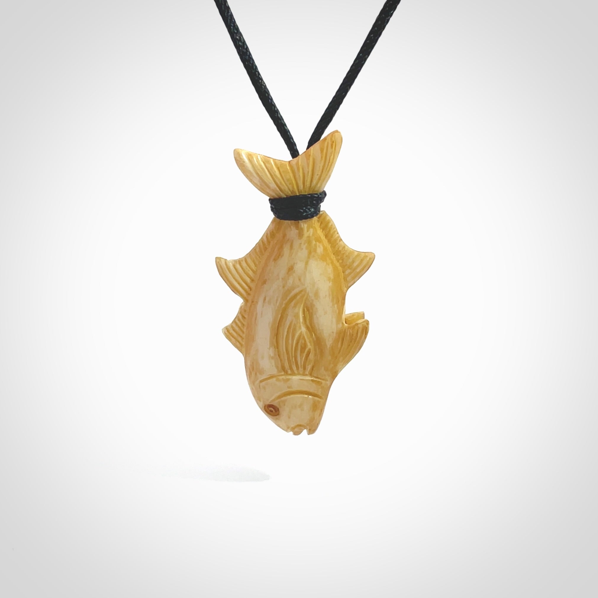 Hand carved stained bone fish pendant. Hand made stained bone fish necklace. Fish themed jewellery. Ocean themed pendant. Bone fish necklace provided with adjustable cord and free delivery.