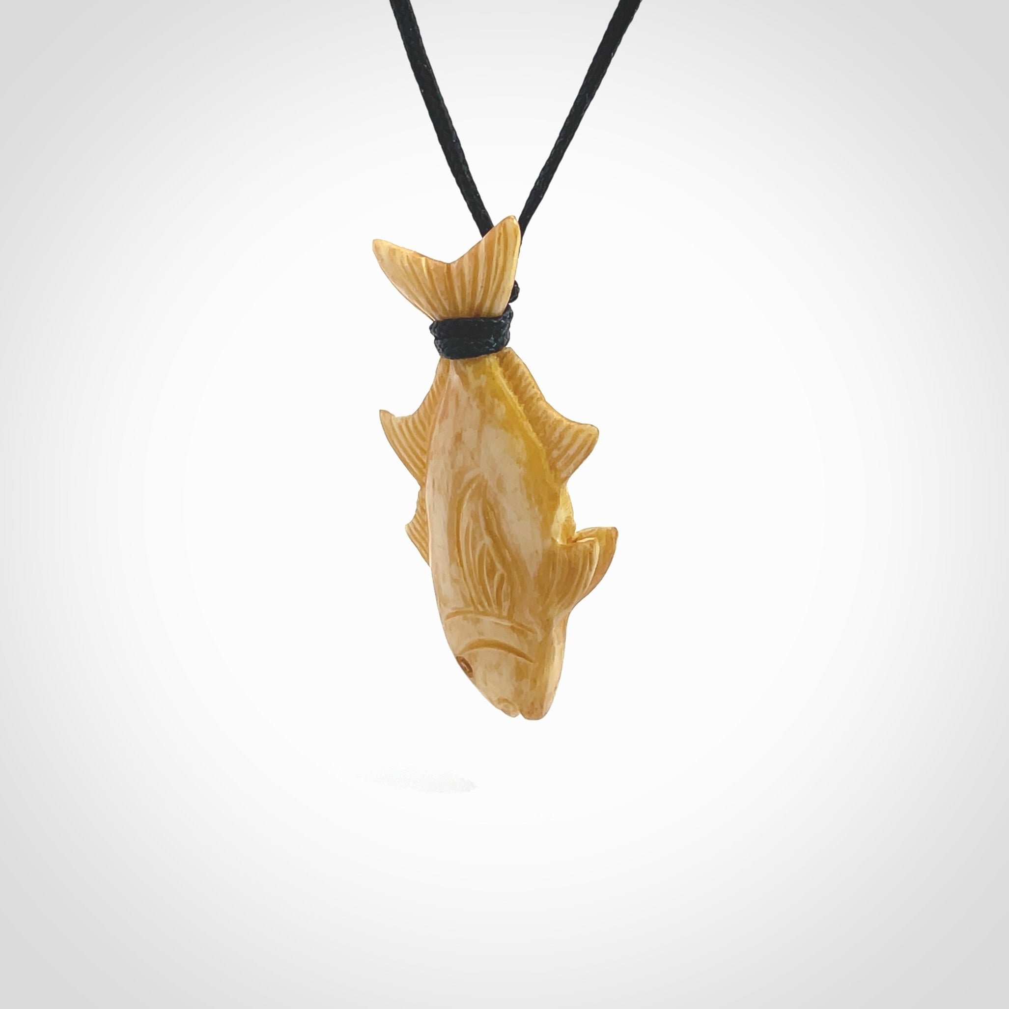 Hand carved stained bone fish pendant. Hand made stained bone fish necklace. Fish themed jewellery. Ocean themed pendant. Bone fish necklace provided with adjustable cord and free delivery.