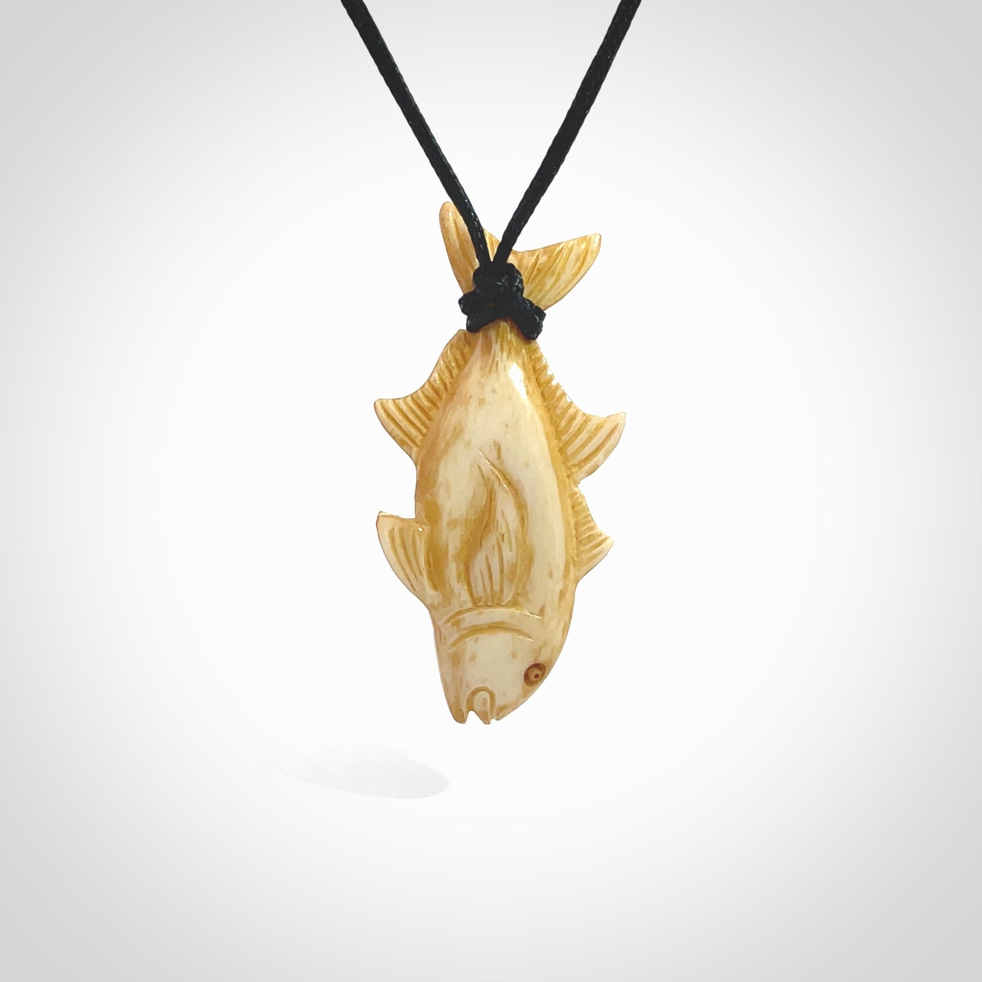 Hand carved stained bone fish pendant. Hand made stained bone fish necklace. Fish themed jewellery. Ocean themed pendant. Bone fish necklace provided with adjustable cord and free delivery.