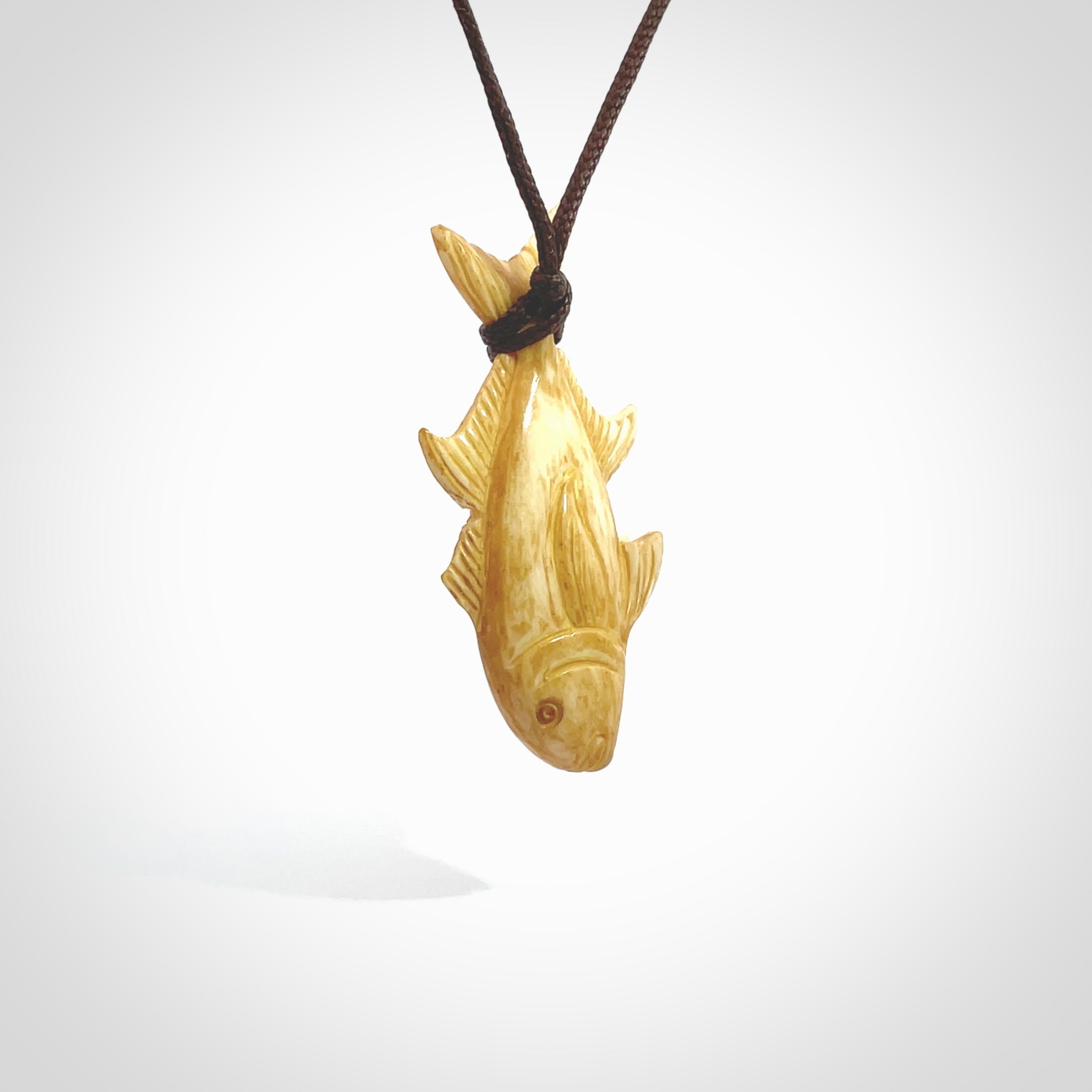 Hand carved stained bone fish pendant. Hand made stained bone fish necklace. Fish themed jewellery. Ocean themed pendant. Bone fish necklace provided with adjustable cord and free delivery.