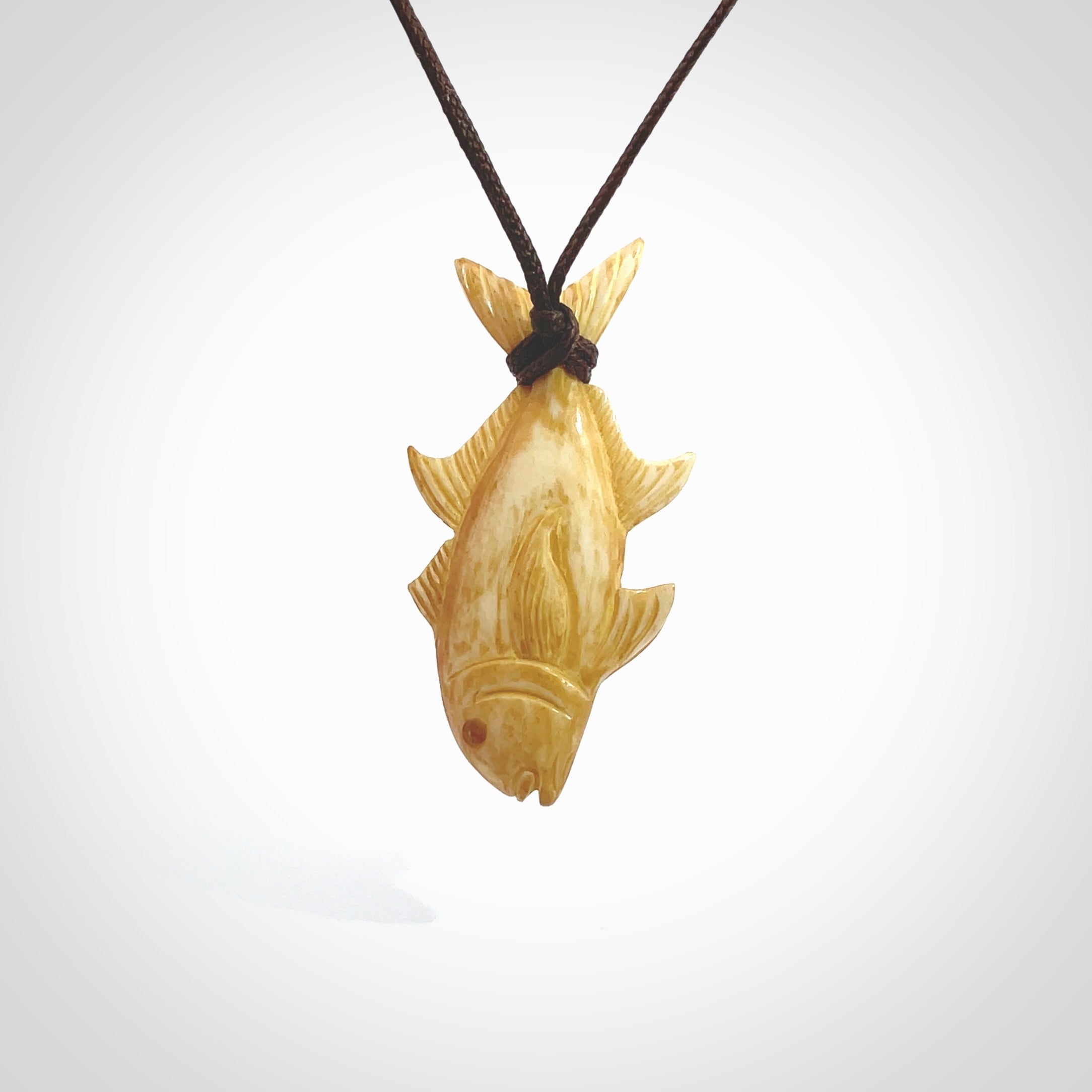 Hand carved stained bone fish pendant. Hand made stained bone fish necklace. Fish themed jewellery. Ocean themed pendant. Bone fish necklace provided with adjustable cord and free delivery.