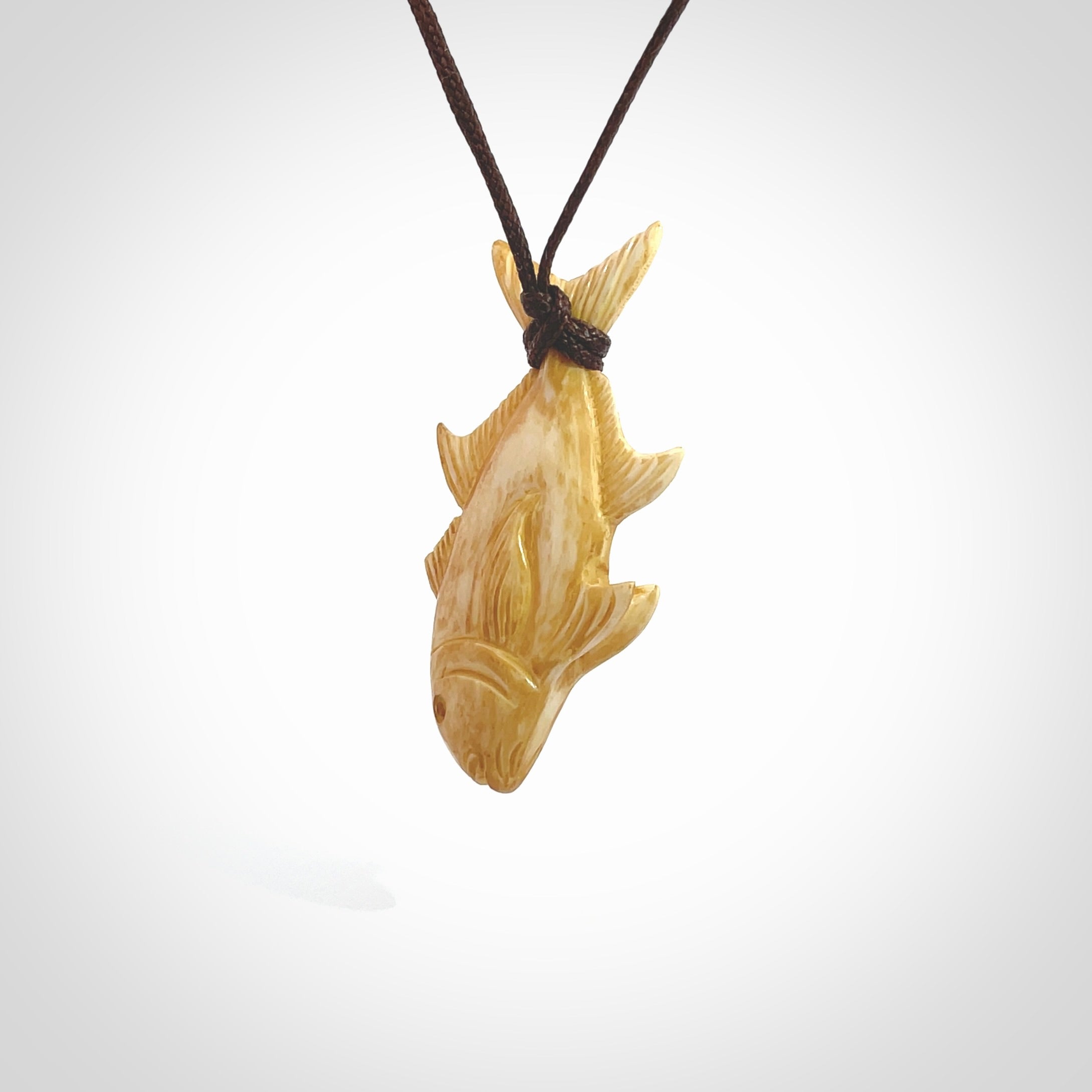 Hand carved stained bone fish pendant. Hand made stained bone fish necklace. Fish themed jewellery. Ocean themed pendant. Bone fish necklace provided with adjustable cord and free delivery.