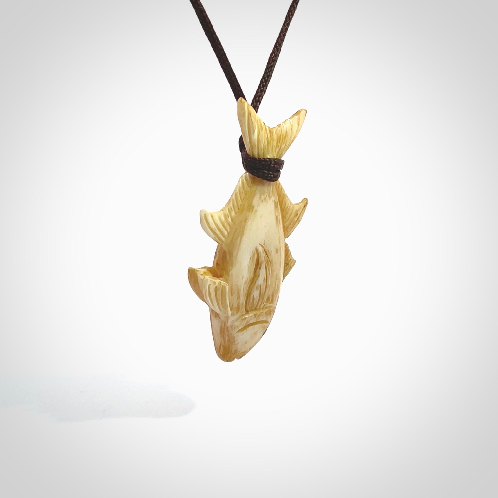 Hand carved stained bone fish pendant. Hand made stained bone fish necklace. Fish themed jewellery. Ocean themed pendant. Bone fish necklace provided with adjustable cord and free delivery.