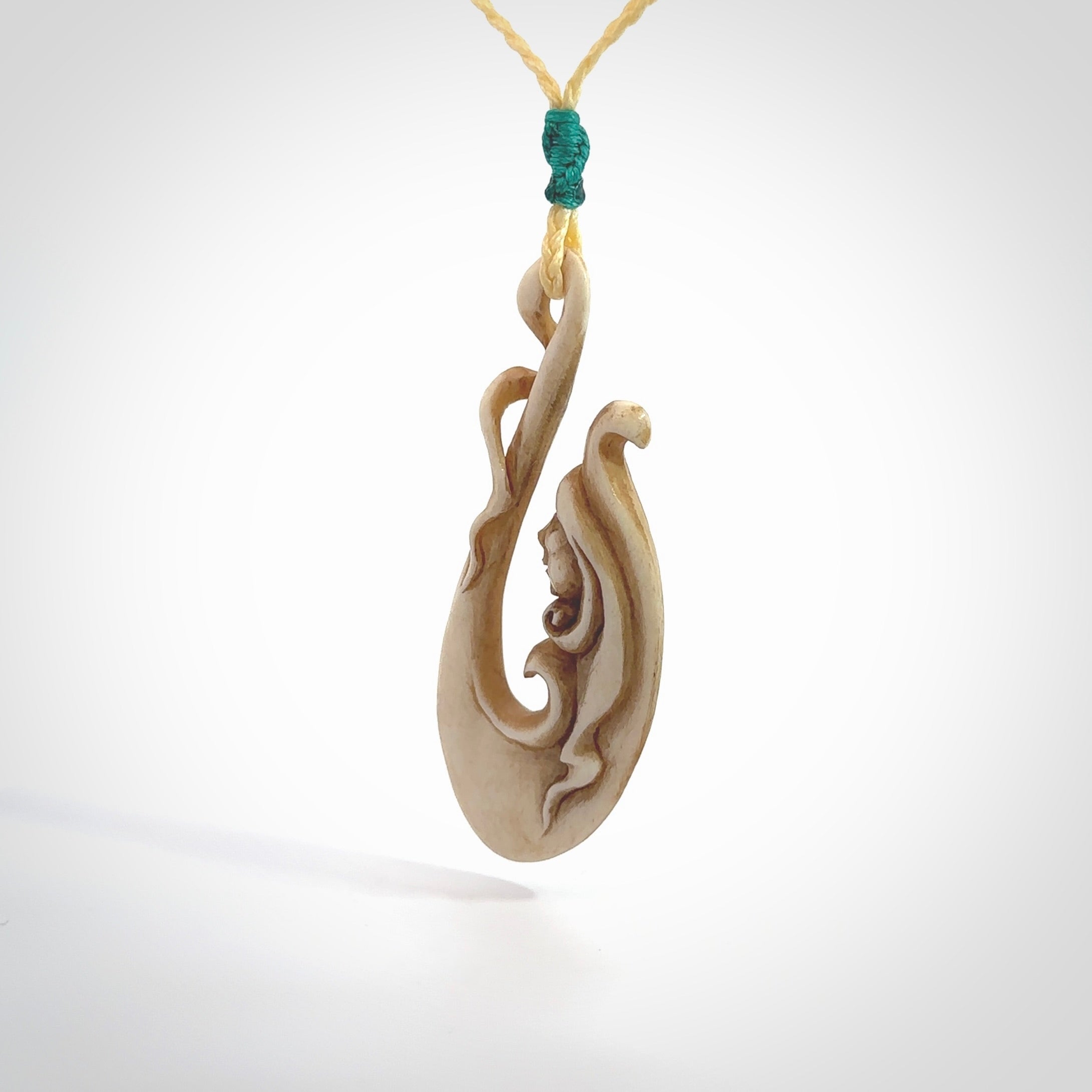 This pendant is a gorgeous and intricately carved mermaid hook pendant. Carved by renowned bone carver Yuri Terenyi for us. This is a masterpiece. It is a mermaid with her tail culminating into a hook. The craftsmanship displayed in this piece is extraordinary - a collectors item, or a piece to wear and love.