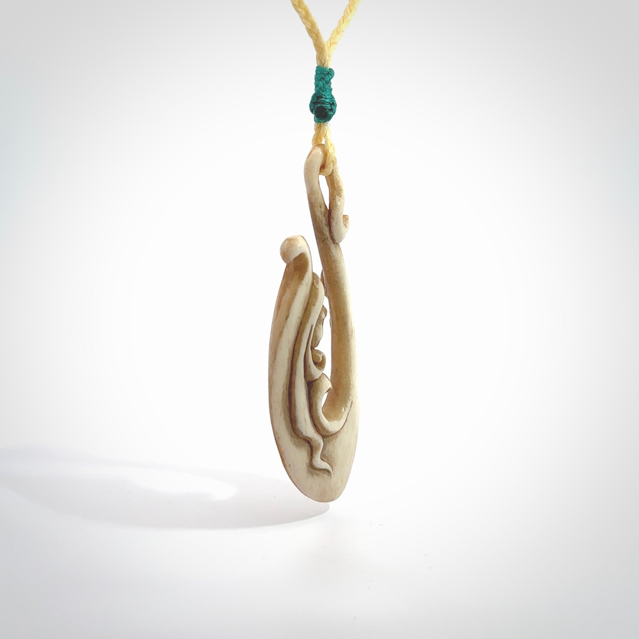 This pendant is a gorgeous and intricately carved mermaid hook pendant. Carved by renowned bone carver Yuri Terenyi for us. This is a masterpiece. It is a mermaid with her tail culminating into a hook. The craftsmanship displayed in this piece is extraordinary - a collectors item, or a piece to wear and love.