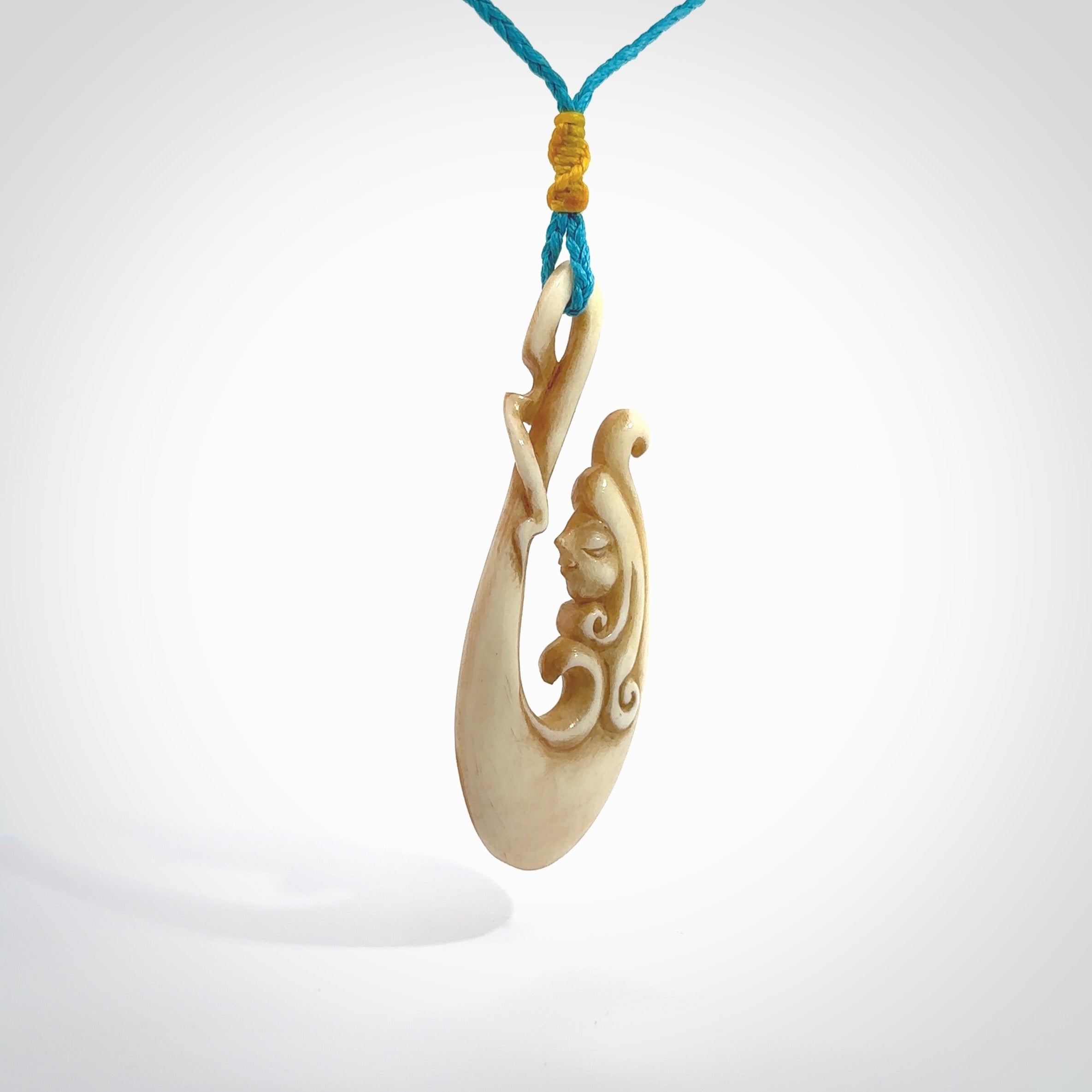 This pendant is a gorgeous and intricately carved mermaid hook pendant. Carved by renowned bone carver Yuri Terenyi for us. This is a masterpiece. It is a mermaid with her tail culminating into a hook. The craftsmanship displayed in this piece is extraordinary - a collectors item, or a piece to wear and love.