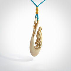 This pendant is a gorgeous and intricately carved mermaid hook pendant. Carved by renowned bone carver Yuri Terenyi for us. This is a masterpiece. It is a mermaid with her tail culminating into a hook. The craftsmanship displayed in this piece is extraordinary - a collectors item, or a piece to wear and love.