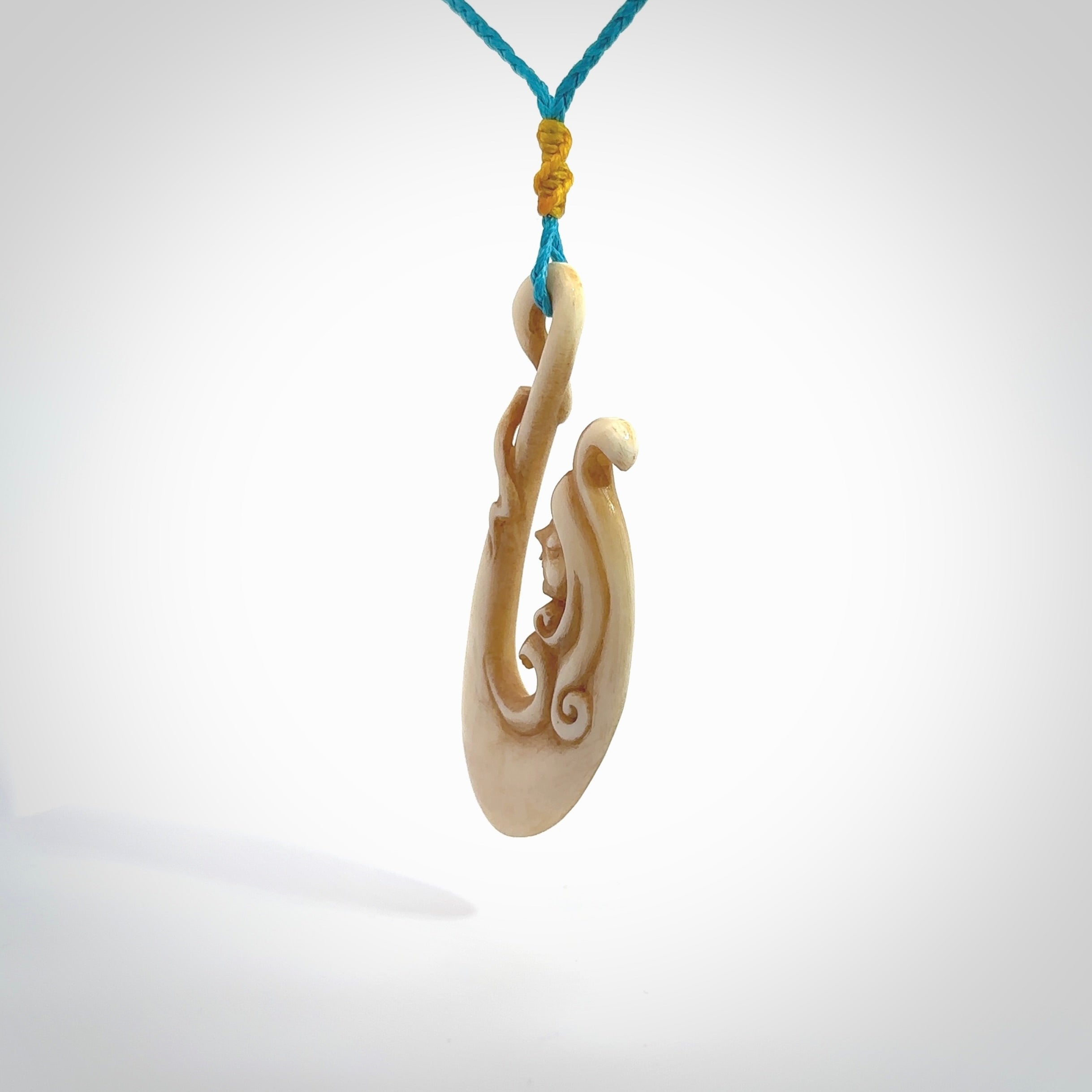 This pendant is a gorgeous and intricately carved mermaid hook pendant. Carved by renowned bone carver Yuri Terenyi for us. This is a masterpiece. It is a mermaid with her tail culminating into a hook. The craftsmanship displayed in this piece is extraordinary - a collectors item, or a piece to wear and love.