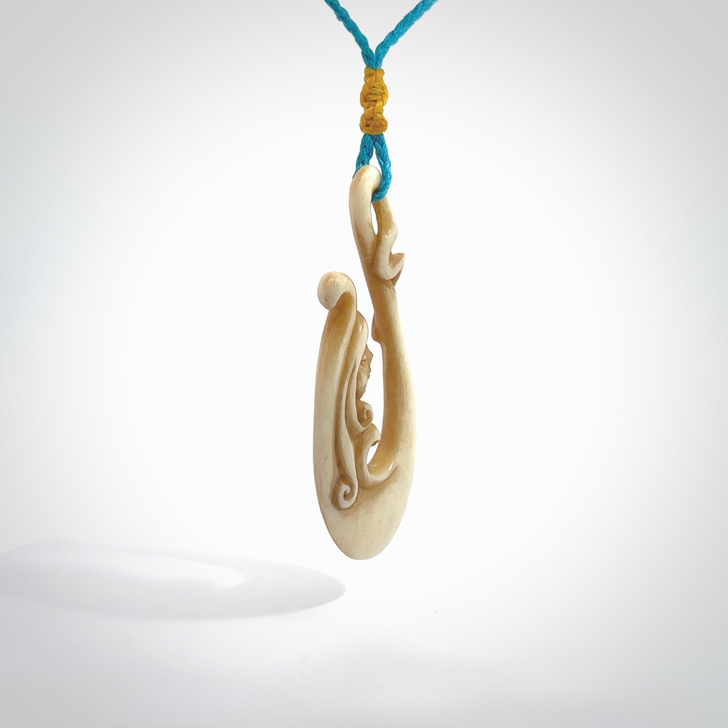 This pendant is a gorgeous and intricately carved mermaid hook pendant. Carved by renowned bone carver Yuri Terenyi for us. This is a masterpiece. It is a mermaid with her tail culminating into a hook. The craftsmanship displayed in this piece is extraordinary - a collectors item, or a piece to wear and love.