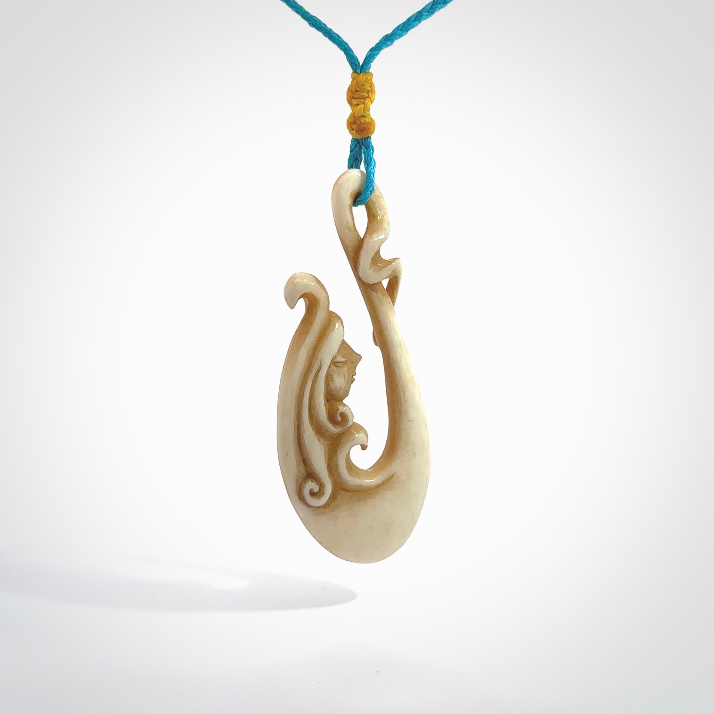 This pendant is a gorgeous and intricately carved mermaid hook pendant. Carved by renowned bone carver Yuri Terenyi for us. This is a masterpiece. It is a mermaid with her tail culminating into a hook. The craftsmanship displayed in this piece is extraordinary - a collectors item, or a piece to wear and love.