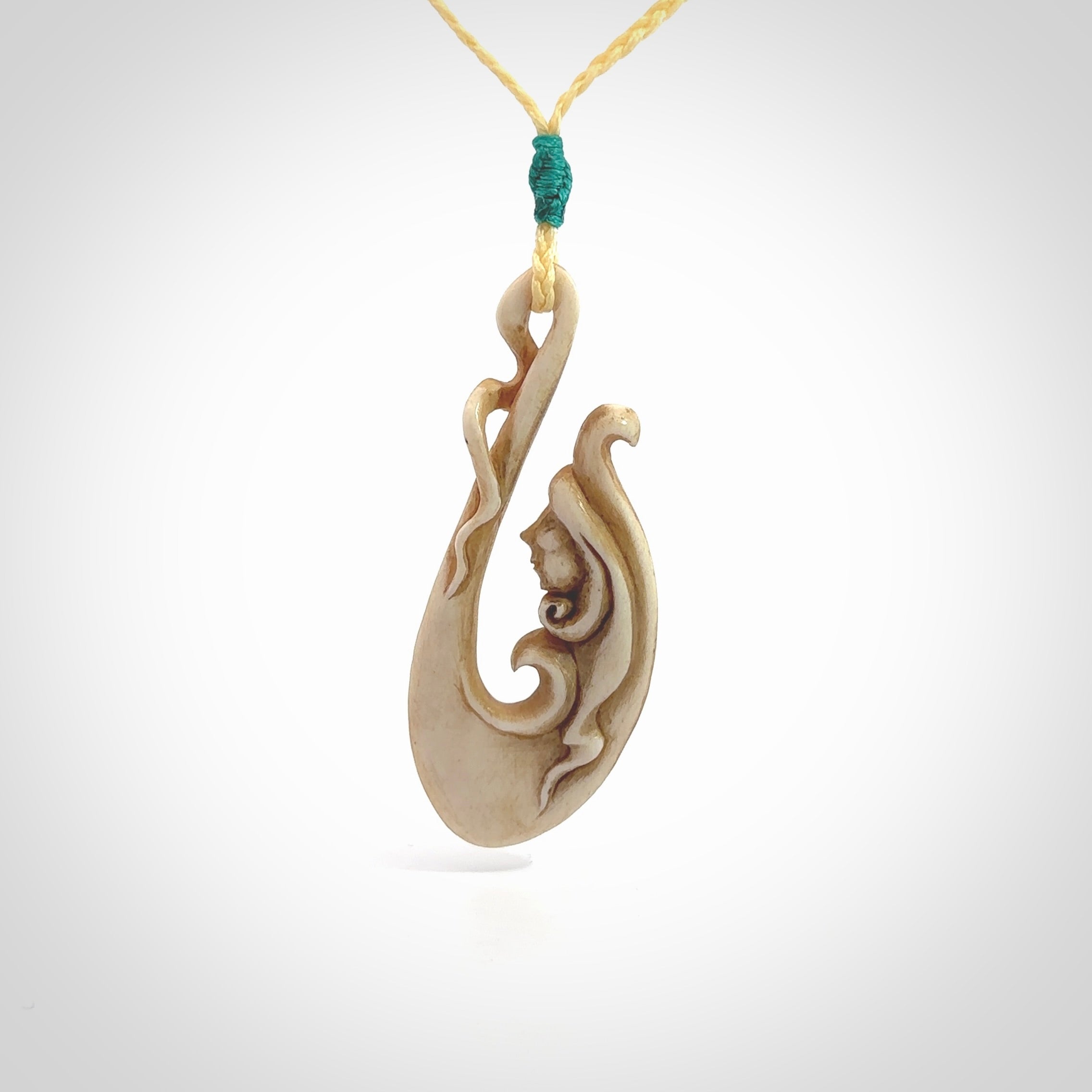 This pendant is a gorgeous and intricately carved mermaid hook pendant. Carved by renowned bone carver Yuri Terenyi for us. This is a masterpiece. It is a mermaid with her tail culminating into a hook. The craftsmanship displayed in this piece is extraordinary - a collectors item, or a piece to wear and love.