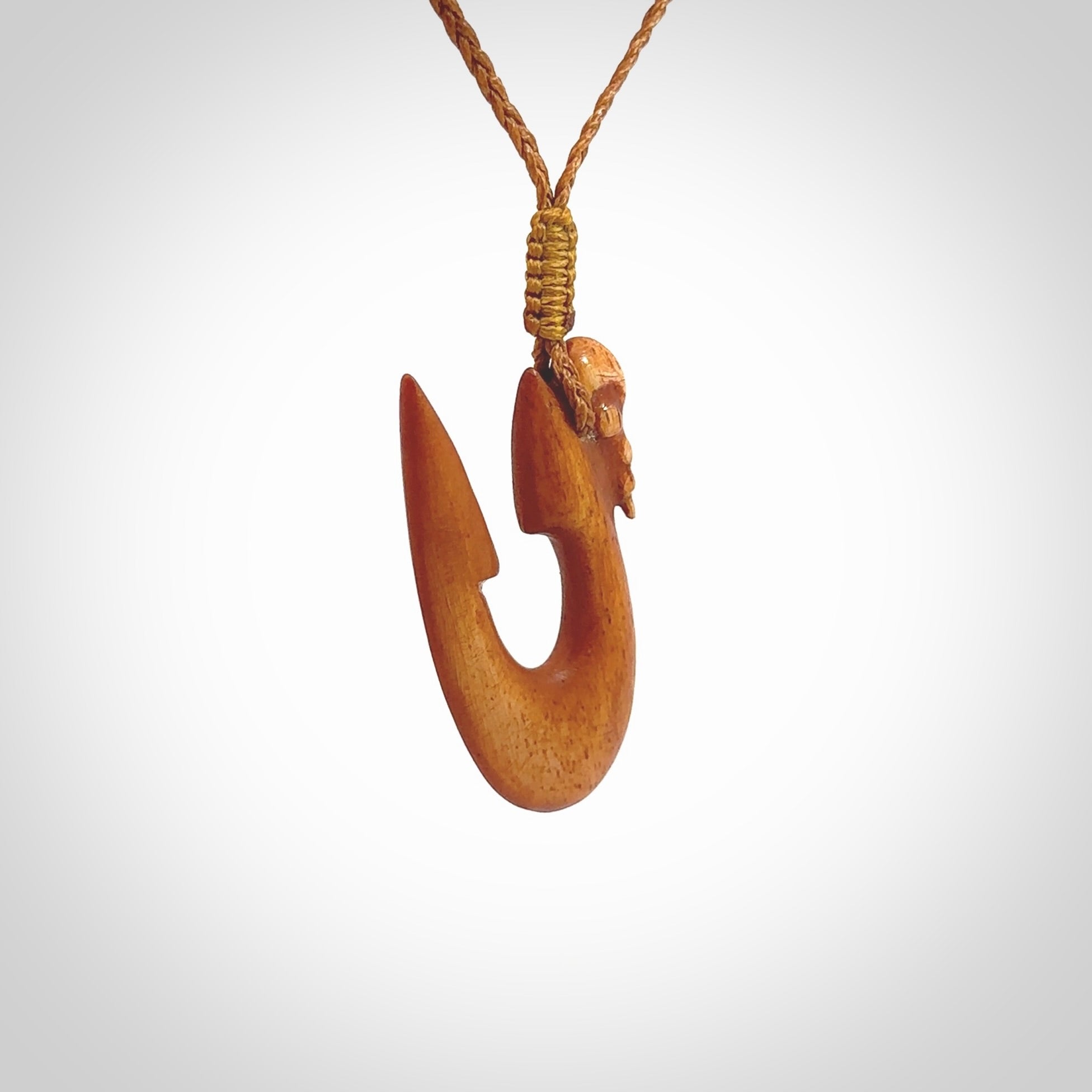 Natural stained cow bone manaia with hook pendant. Hand carved by Yuri Terenyi in New Zealand. Unique design pendant for sale online. One only stained bone manaia, hook necklace. Free delivery worldwide. Delivered with an adjustable cord.