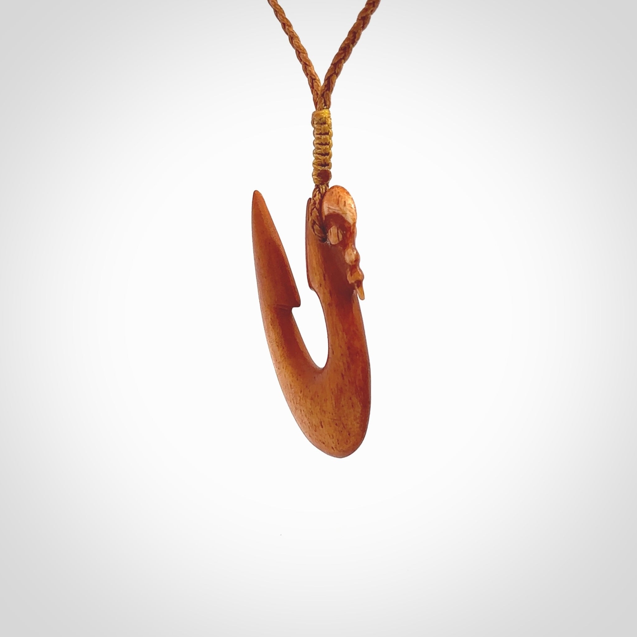 Natural stained cow bone manaia with hook pendant. Hand carved by Yuri Terenyi in New Zealand. Unique design pendant for sale online. One only stained bone manaia, hook necklace. Free delivery worldwide. Delivered with an adjustable cord.