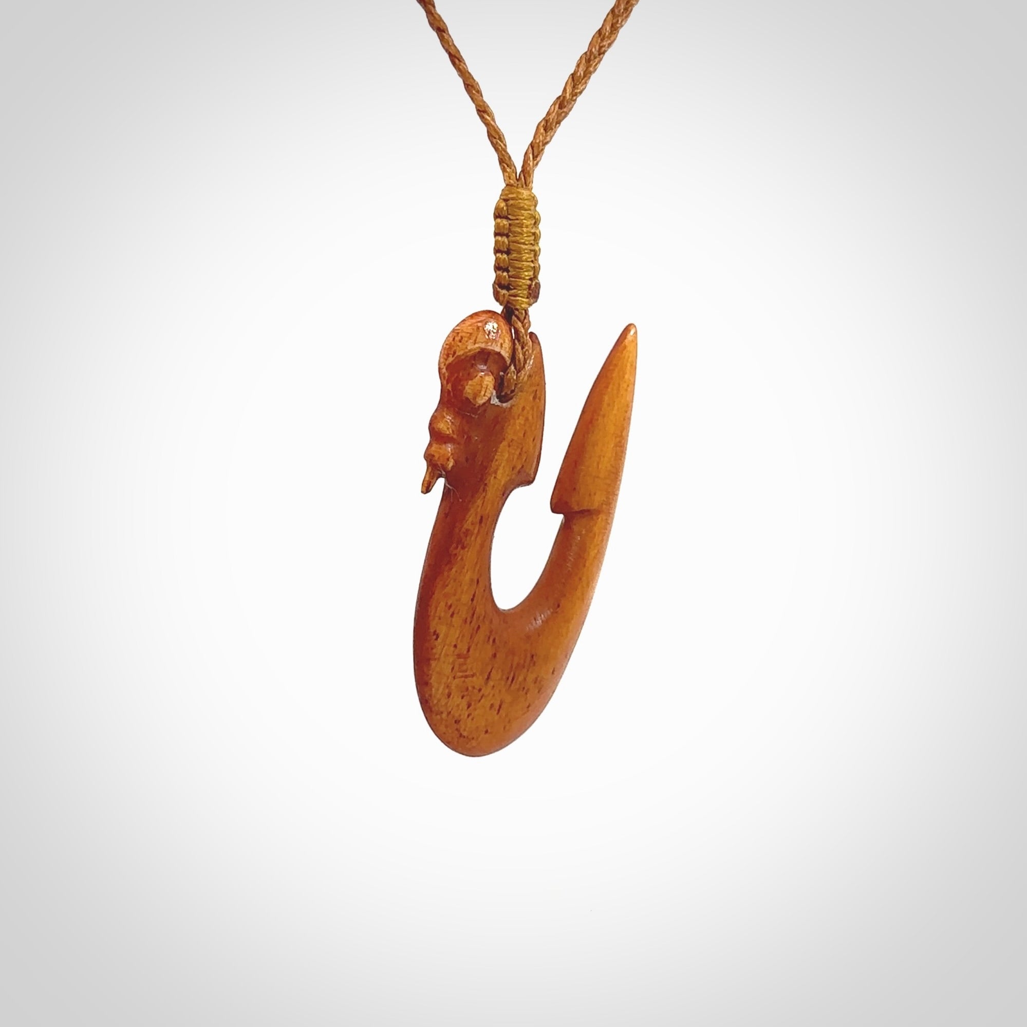 Natural stained cow bone manaia with hook pendant. Hand carved by Yuri Terenyi in New Zealand. Unique design pendant for sale online. One only stained bone manaia, hook necklace. Free delivery worldwide. Delivered with an adjustable cord.