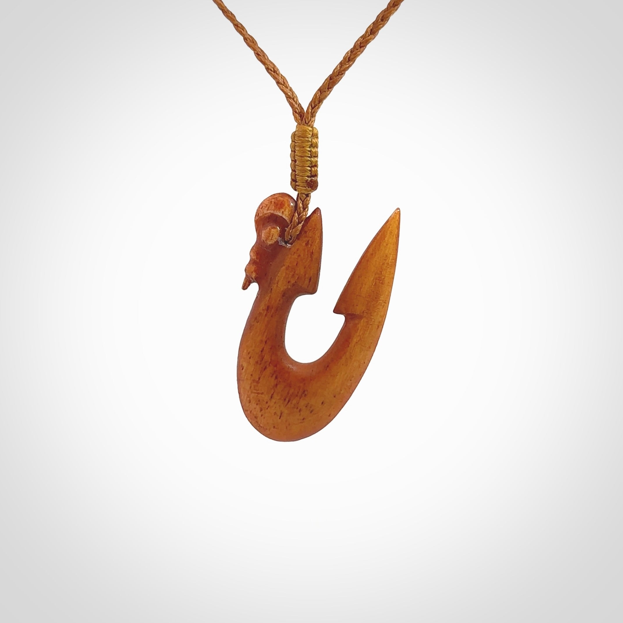 Natural stained cow bone manaia with hook pendant. Hand carved by Yuri Terenyi in New Zealand. Unique design pendant for sale online. One only stained bone manaia, hook necklace. Free delivery worldwide. Delivered with an adjustable cord.