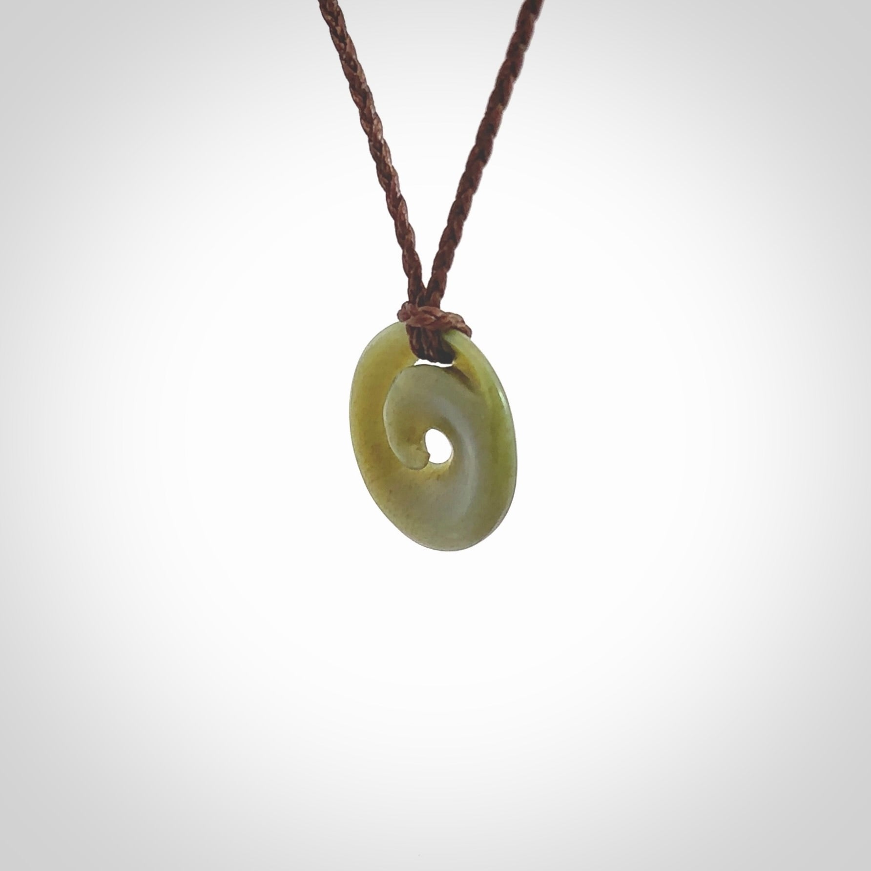 This little pendant is a beautifully carved, small jade koru pendant. Hand Carved for NZ Pacific by Graeme Wylie. Jade jewelry for sale online exclusively with NZ Pacific.