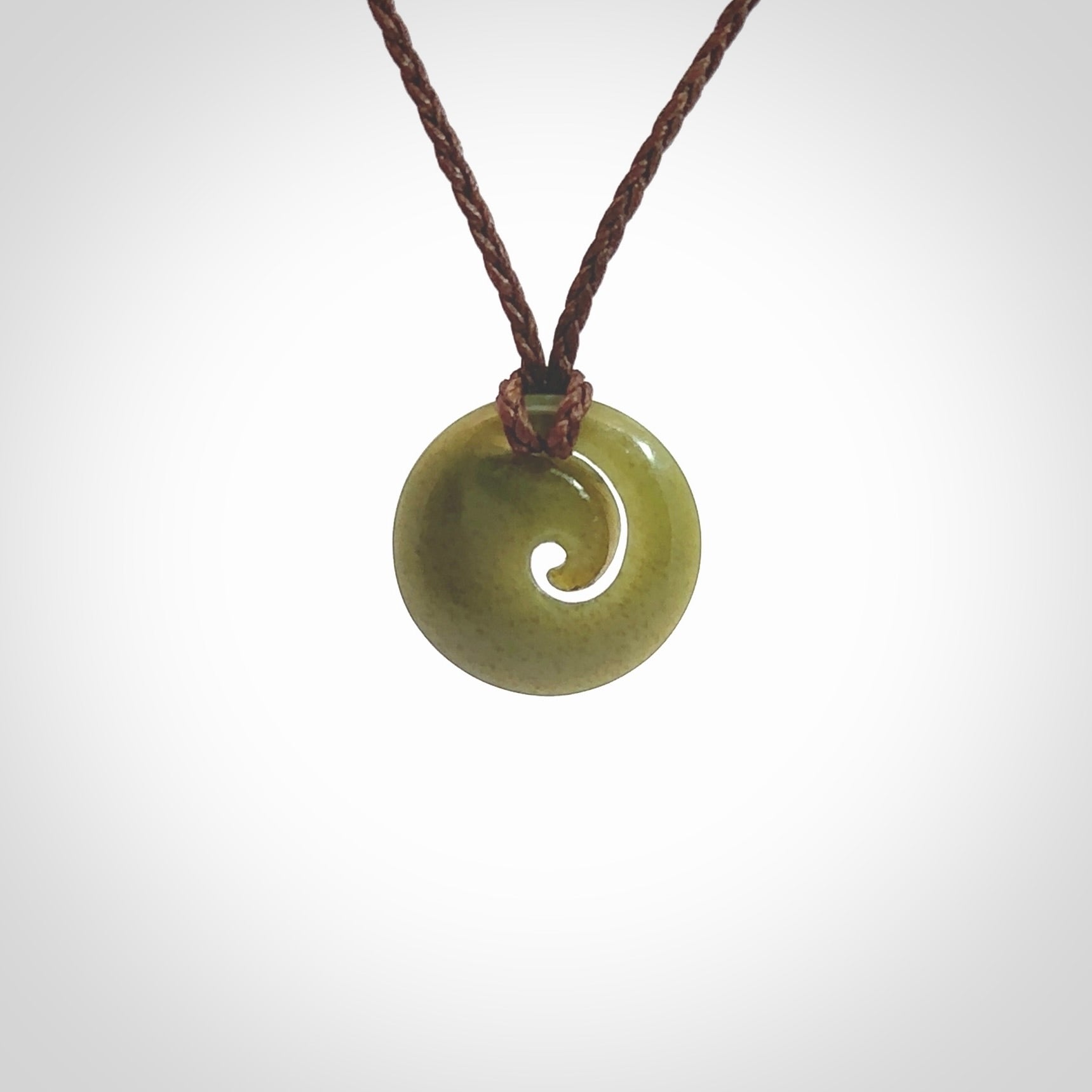 This little pendant is a beautifully carved, small jade koru pendant. Hand Carved for NZ Pacific by Graeme Wylie. Jade jewelry for sale online exclusively with NZ Pacific.