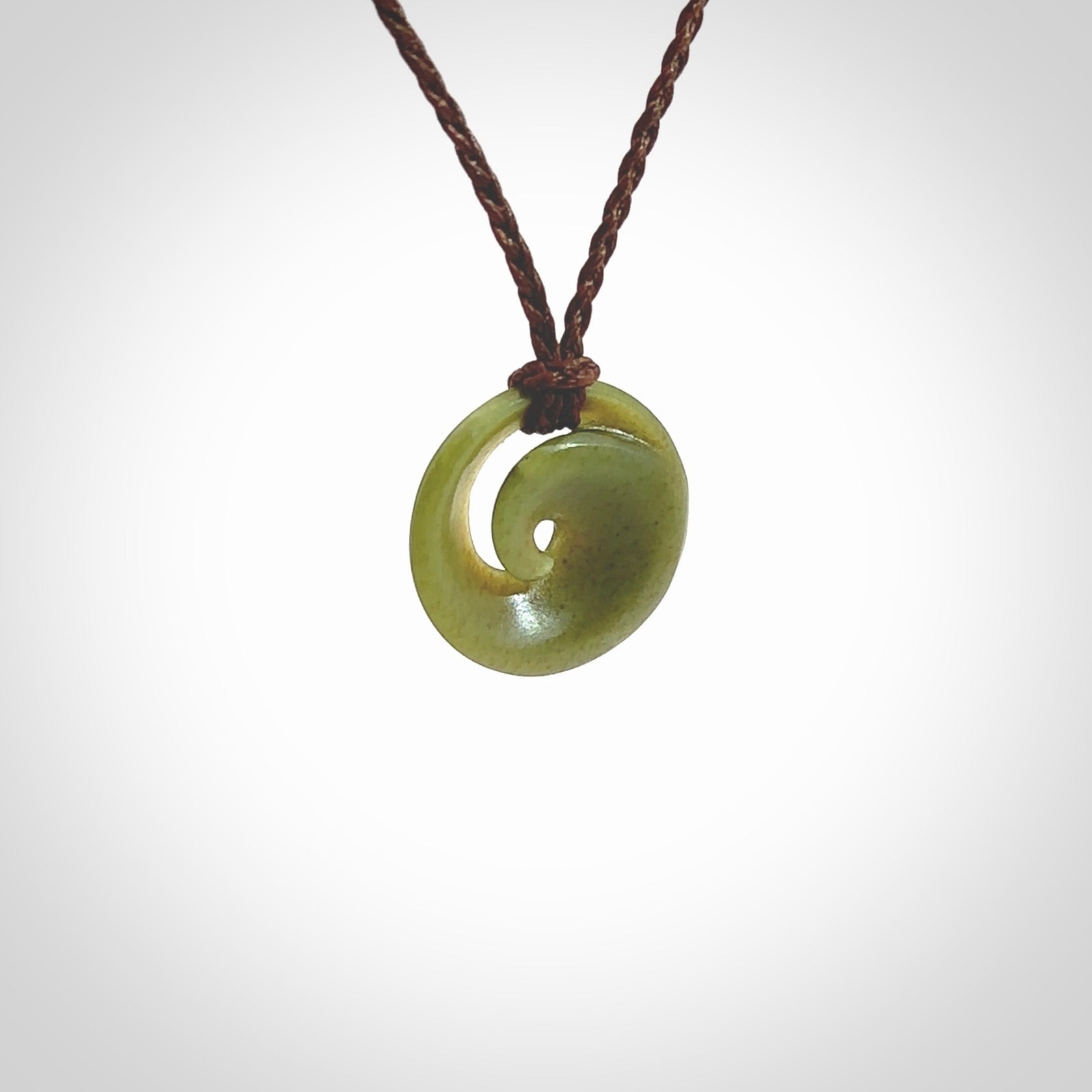 This little pendant is a beautifully carved, small jade koru pendant. Hand Carved for NZ Pacific by Graeme Wylie. Jade jewelry for sale online exclusively with NZ Pacific.