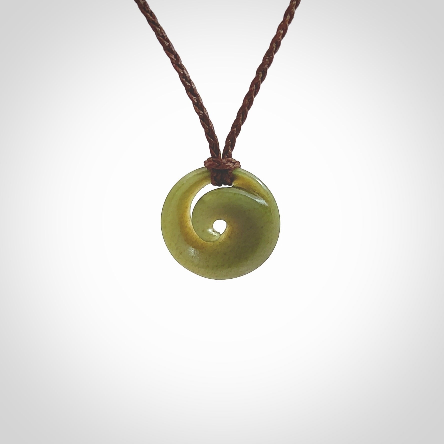 This little pendant is a beautifully carved, small jade koru pendant. Hand Carved for NZ Pacific by Graeme Wylie. Jade jewelry for sale online exclusively with NZ Pacific.