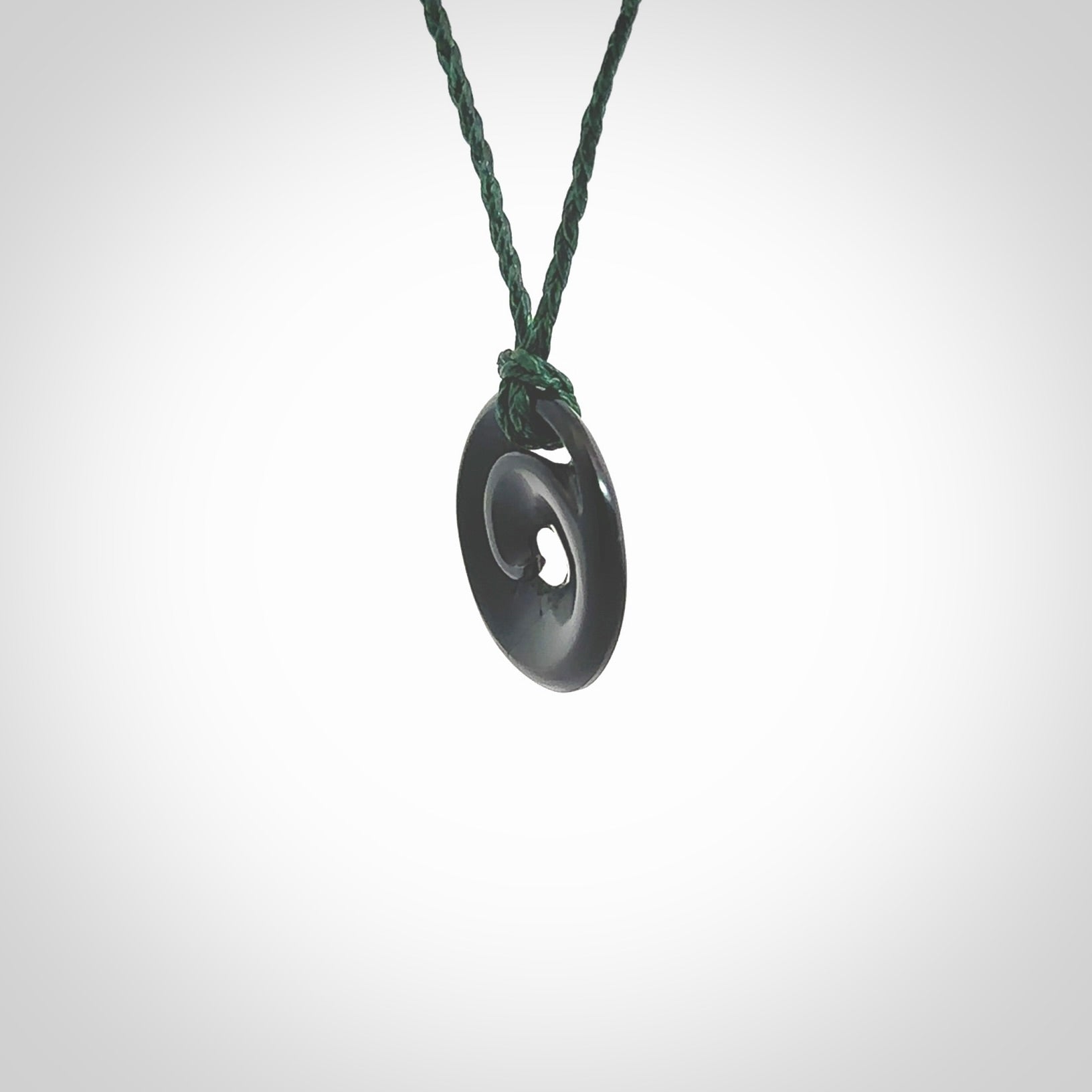 This little pendant is a beautifully carved, small jade koru pendant. Hand Carved for NZ Pacific by Graeme Wylie. Jade jewelry for sale online exclusively with NZ Pacific.