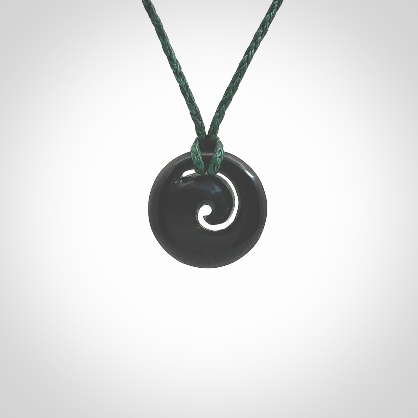 This little pendant is a beautifully carved, small jade koru pendant. Hand Carved for NZ Pacific by Graeme Wylie. Jade jewelry for sale online exclusively with NZ Pacific.