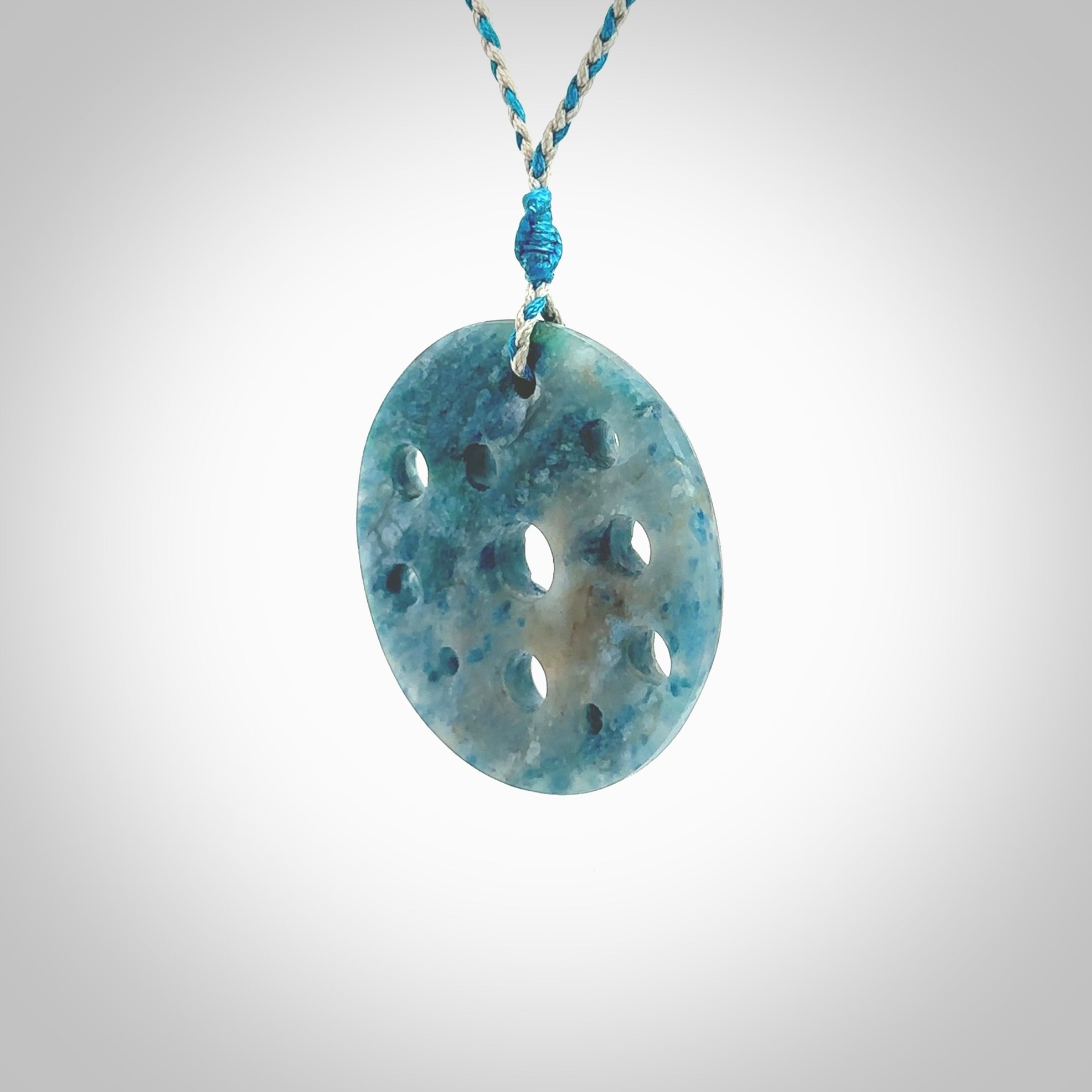 This is a handcrafted aotea stone disc pendant. This is a solid contemporary work of art. We ship this worldwide express courier and are happy to answer any questions that you may have about these or other products on our website. Hand made by Ana Krakosky.