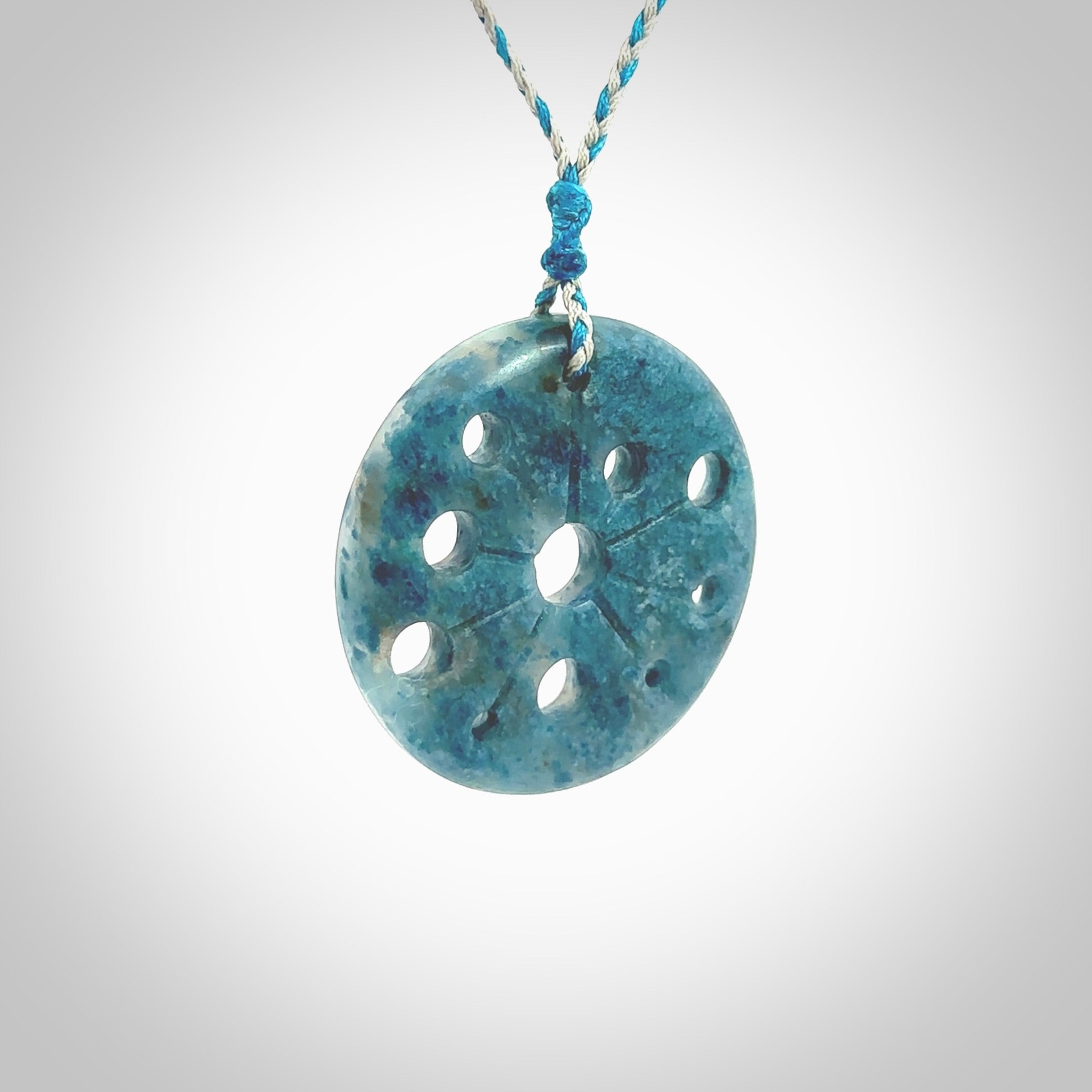 This is a handcrafted aotea stone disc pendant. This is a solid contemporary work of art. We ship this worldwide express courier and are happy to answer any questions that you may have about these or other products on our website. Hand made by Ana Krakosky.