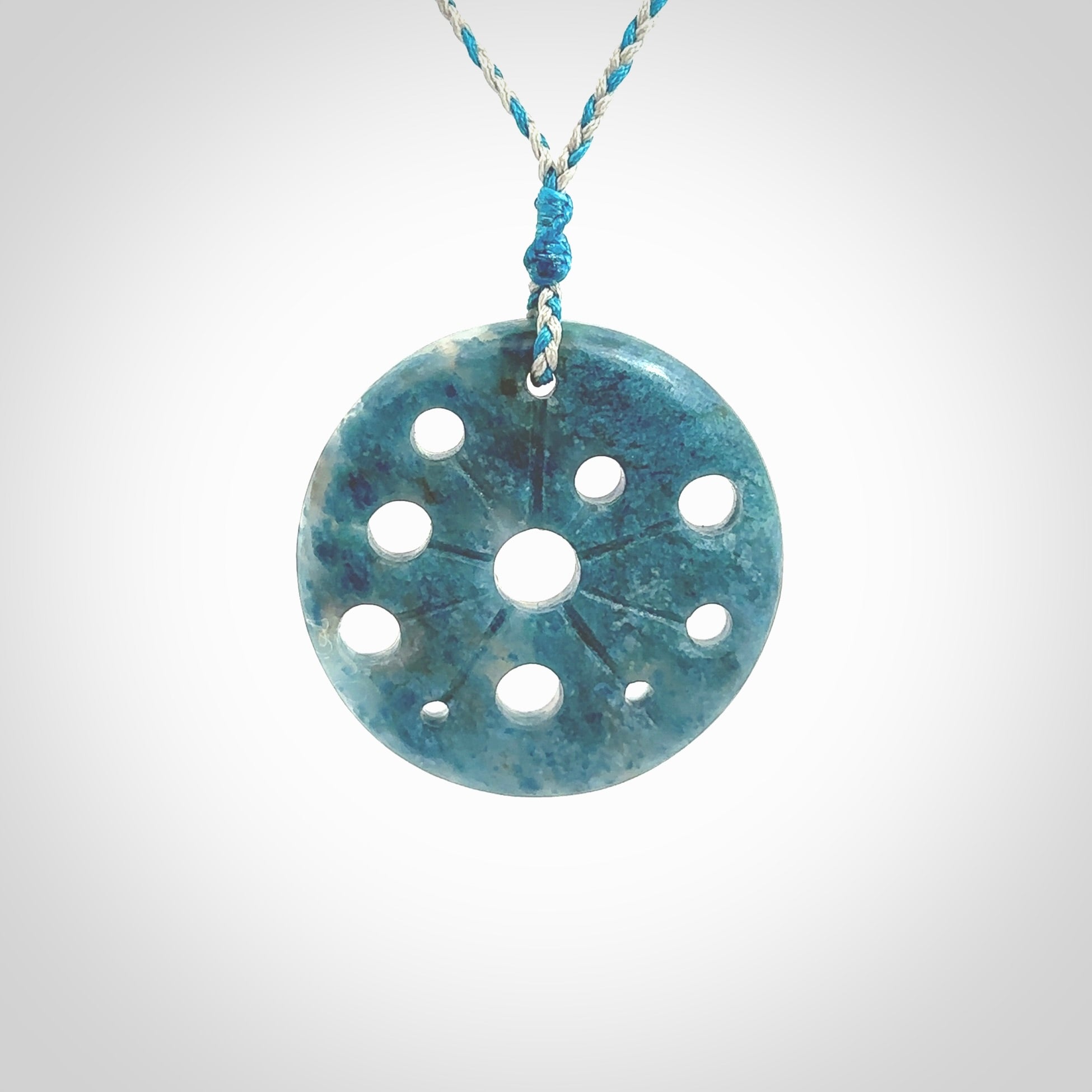 This is a handcrafted aotea stone disc pendant. This is a solid contemporary work of art. We ship this worldwide express courier and are happy to answer any questions that you may have about these or other products on our website. Hand made by Ana Krakosky.