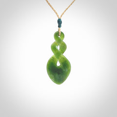 Hand carved New Zealand jade twist pendant. Carved in New Zealand by NZ Pacific. Unique double twist jewellery for sale online. Provided with an adjustable tan cord.