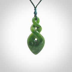 Hand carved New Zealand jade twist pendant. Carved in New Zealand by NZ Pacific. Unique double twist jewellery for sale online. Provided with an adjustable Manuka Green cord.