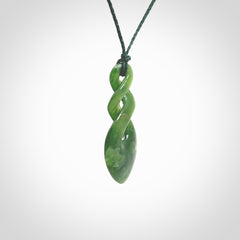 Hand carved New Zealand jade twist pendant. Carved in New Zealand by NZ Pacific. Unique double twist jewellery for sale online. Provided with an adjustable Manuka Green cord.