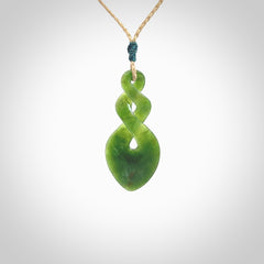 Hand carved New Zealand jade twist pendant. Carved in New Zealand by NZ Pacific. Unique double twist jewellery for sale online. Provided with an adjustable tan cord.