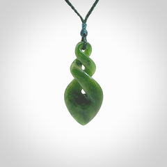 Hand carved New Zealand jade twist pendant. Carved in New Zealand by NZ Pacific. Unique double twist jewellery for sale online. Provided with an adjustable Manuka Green cord.