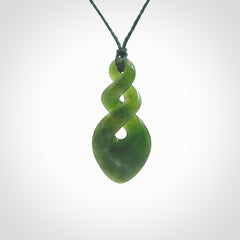 Hand carved New Zealand jade twist pendant. Carved in New Zealand by NZ Pacific. Unique double twist jewellery for sale online. Provided with an adjustable Manuka Green cord.