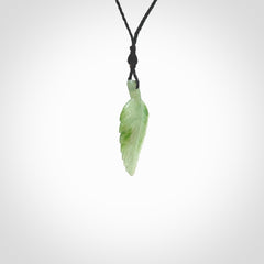 A delicate green jade fern leaf pendant with an adjustable neck cord. Green stone fern leaf necklace with adjustable cord. Delivery included.