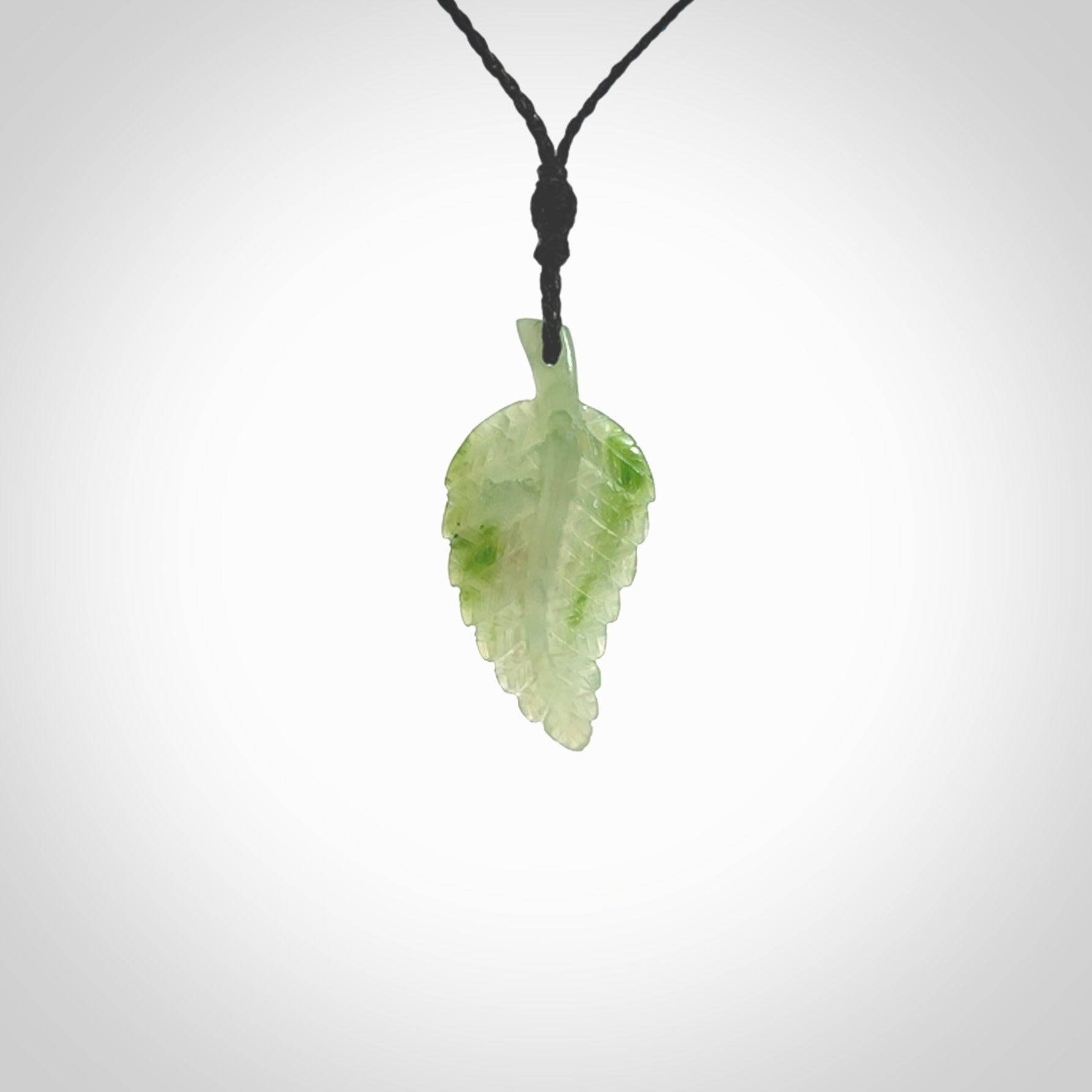 A delicate green jade fern leaf pendant with an adjustable neck cord. Green stone fern leaf necklace with adjustable cord. Delivery included.