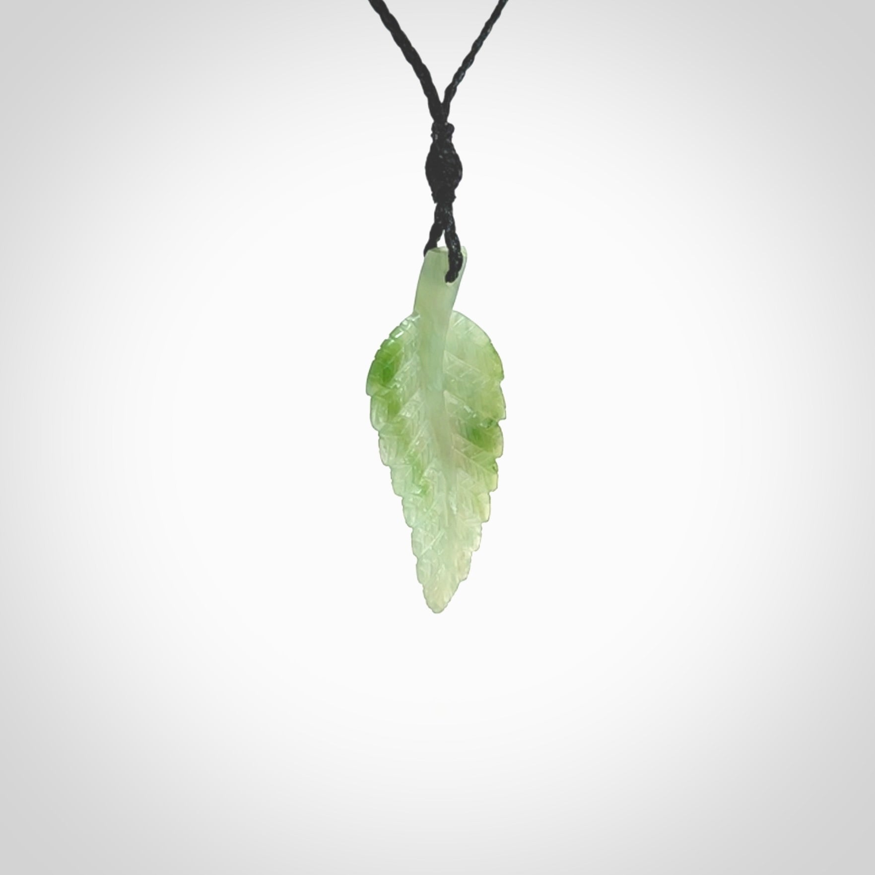 A delicate green jade fern leaf pendant with an adjustable neck cord. Green stone fern leaf necklace with adjustable cord. Delivery included.