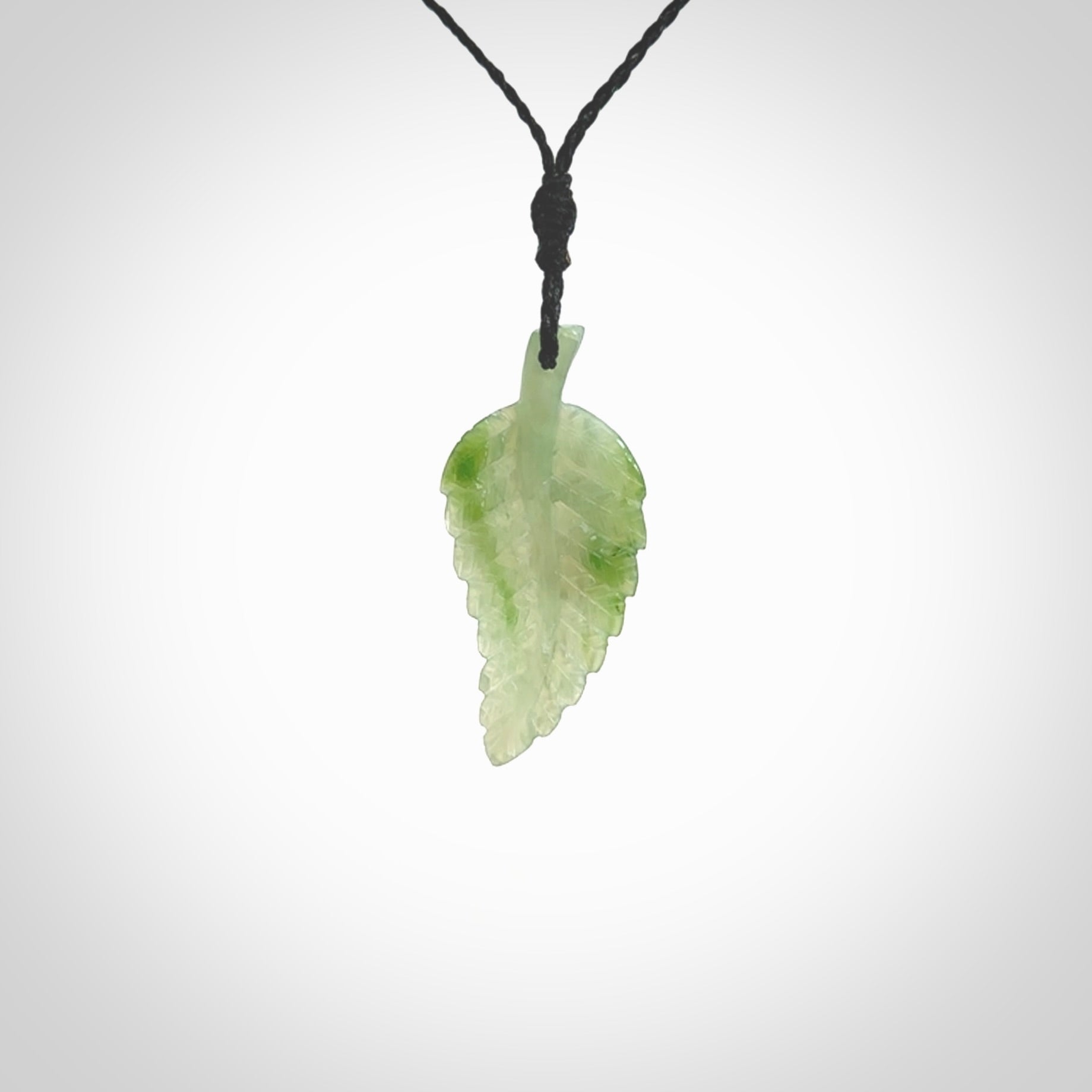 A delicate green jade fern leaf pendant with an adjustable neck cord. Green stone fern leaf necklace with adjustable cord. Delivery included.