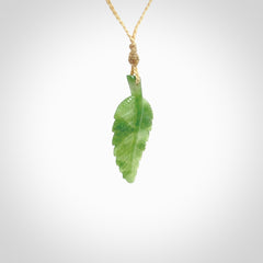 A delicate green jade fern leaf pendant with an adjustable neck cord. Green stone fern leaf necklace with adjustable cord. Delivery included.