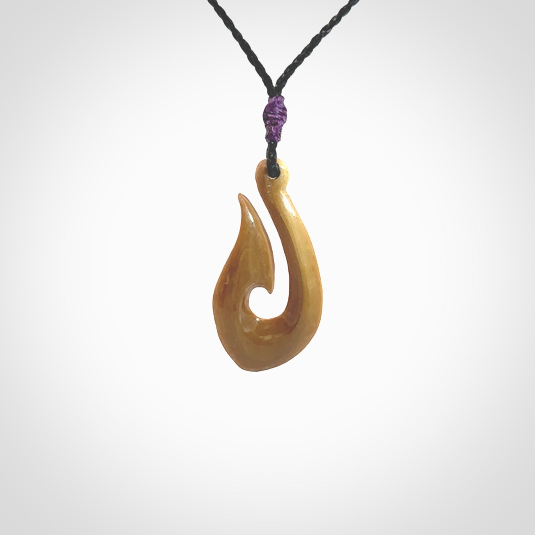 A fish hook necklace (hei-matau) hand-carved in a traditional style from Woolly Mammoth Tusk. These are glorious pieces of art to wear. Provided with adjustable cords and packaged in a woven kete pouch. Delivered with express courier.