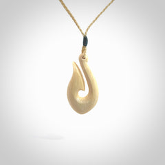 A fish hook necklace (hei-matau) hand-carved in a traditional style from Woolly Mammoth Tusk. These are glorious pieces of art to wear. Provided with adjustable cords and packaged in a woven kete pouch. Delivered with express courier.