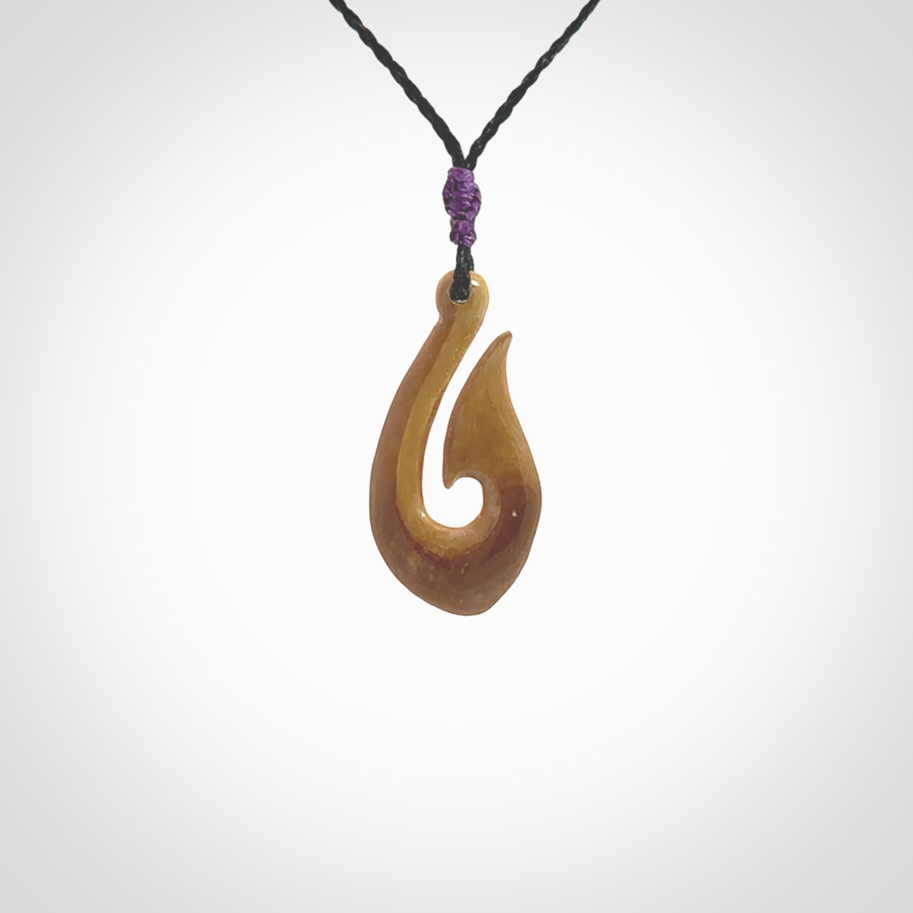 A fish hook necklace (hei-matau) hand-carved in a traditional style from Woolly Mammoth Tusk. These are glorious pieces of art to wear. Provided with adjustable cords and packaged in a woven kete pouch. Delivered with express courier.