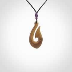 A fish hook necklace (hei-matau) hand-carved in a traditional style from Woolly Mammoth Tusk. These are glorious pieces of art to wear. Provided with adjustable cords and packaged in a woven kete pouch. Delivered with express courier.