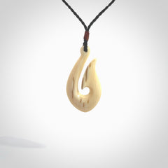 A fish hook necklace (hei-matau) hand-carved in a traditional style from Woolly Mammoth Tusk. These are glorious pieces of art to wear. Provided with adjustable cords and packaged in a woven kete pouch. Delivered with express courier.