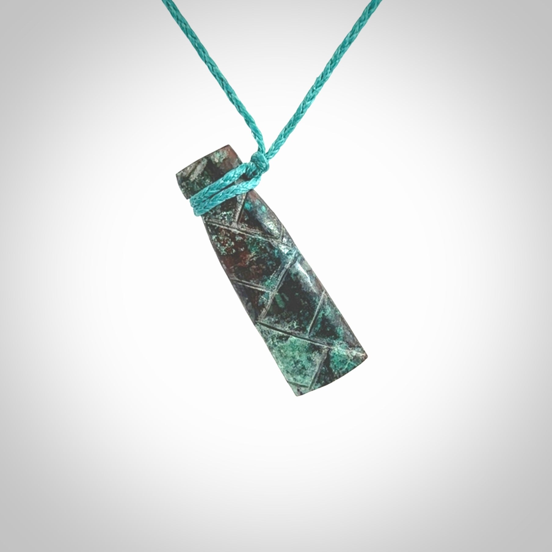 This is a hand carved drop pendant made from a gorgeous and striking piece of African Turquoise stone. For sale online from NZ Pacific. Delivered with adjustable blue cord.