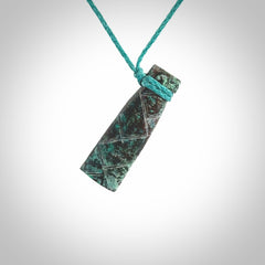 This is a hand carved drop pendant made from a gorgeous and striking piece of African Turquoise stone. For sale online from NZ Pacific. Delivered with adjustable blue cord.