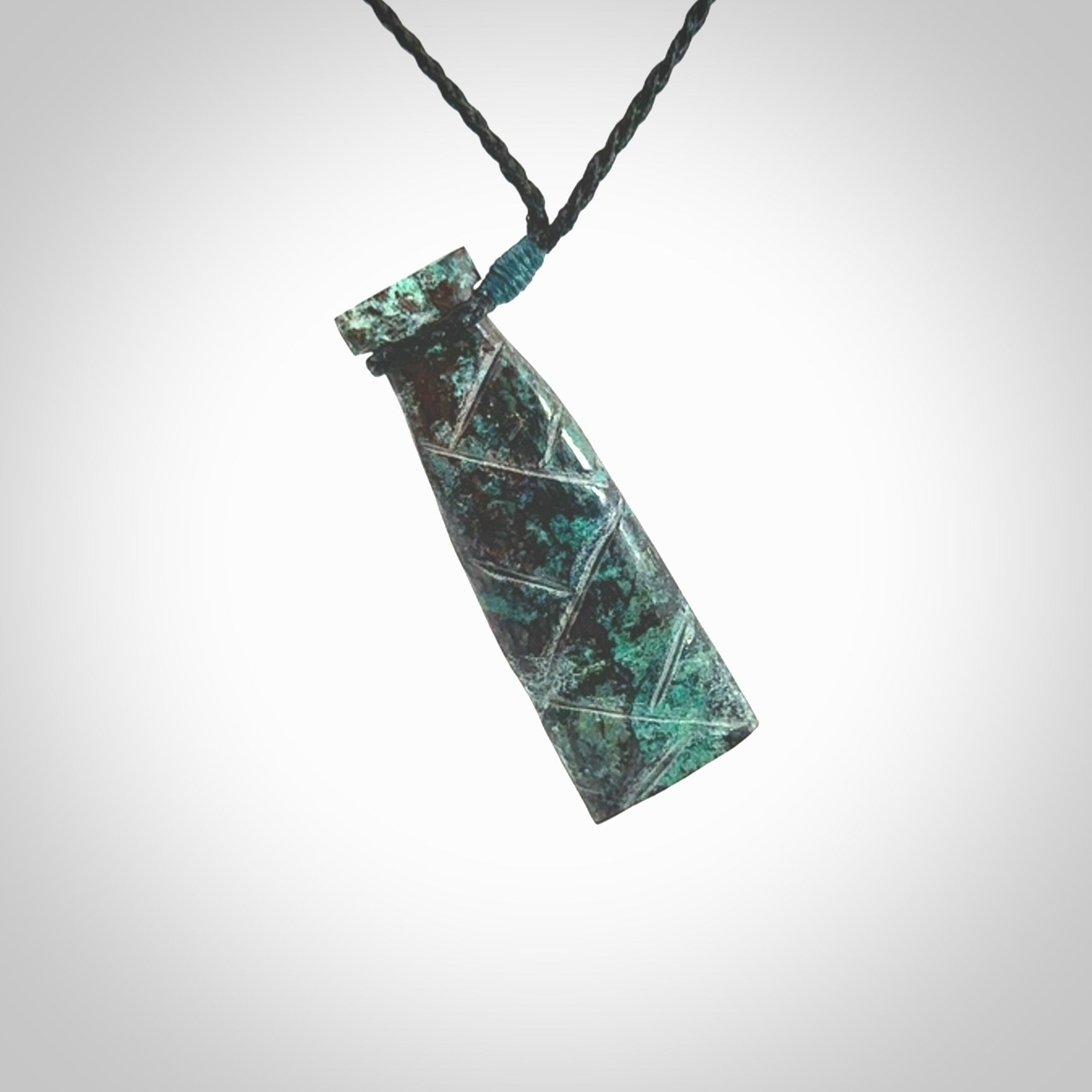 This is a hand carved drop pendant made from a gorgeous and striking piece of African Turquoise stone. For sale online from NZ Pacific. Delivered with adjustable black cord.