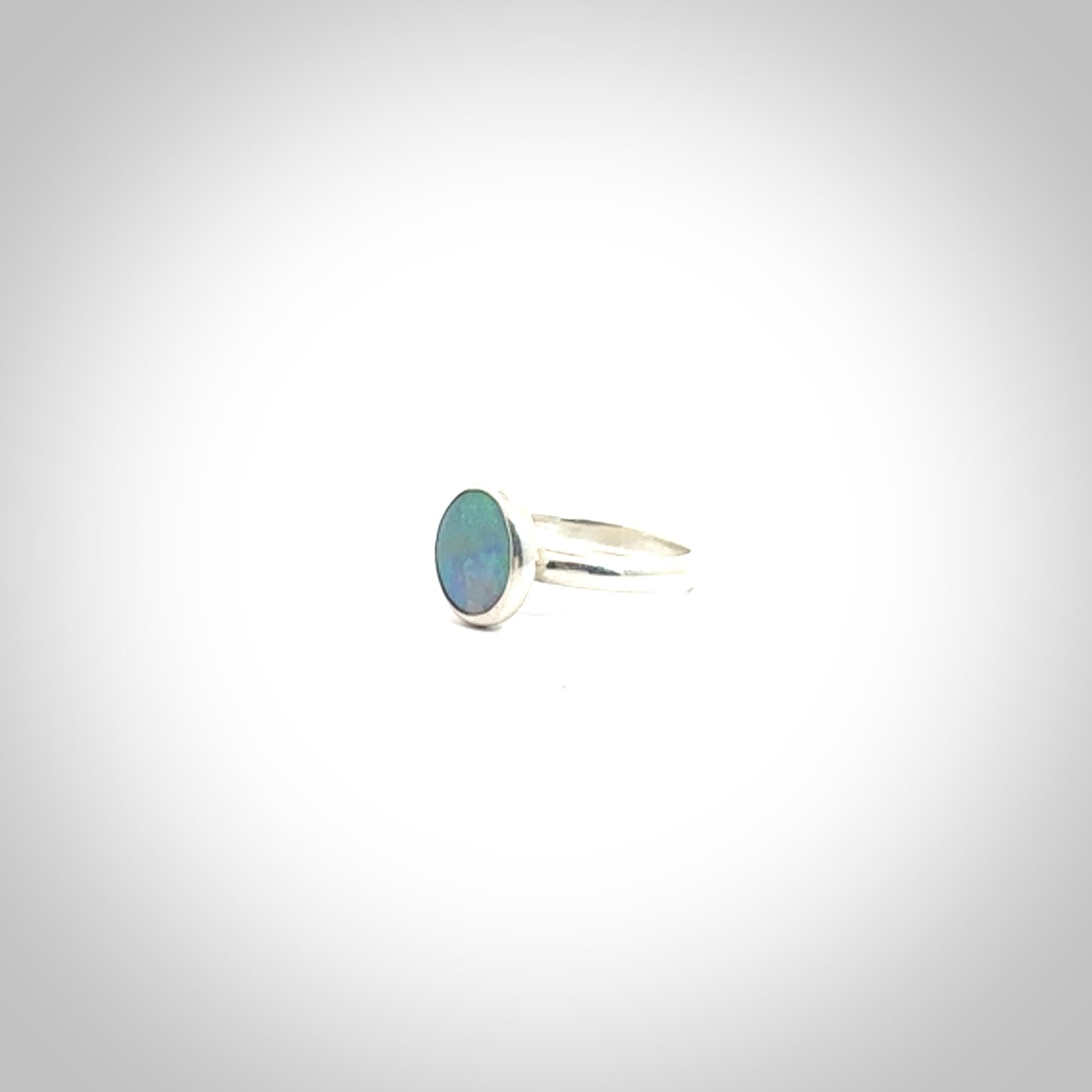 This is a handcrafted real opal ring with sterling silver. The colours are a gorgeous turquoise blue. This is a solid little work of art. We ship this worldwide for free and are happy to answer any questions that you may have about these or other products on our website.